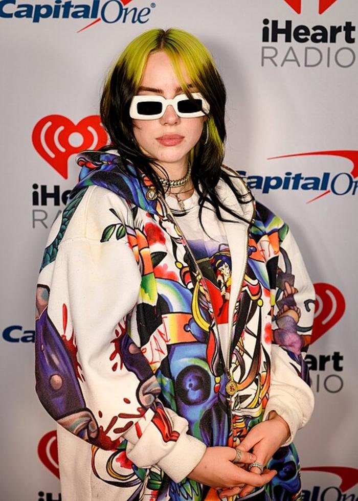 Billie Eilish on stage in colourful streetwear