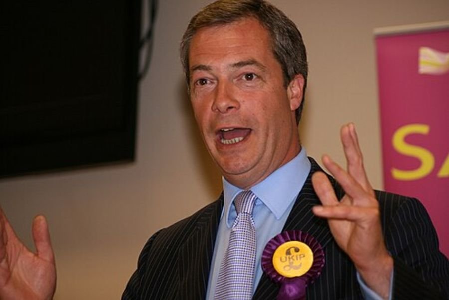 Man speaking while wearing a purple rosette, used in the road to Westminster section