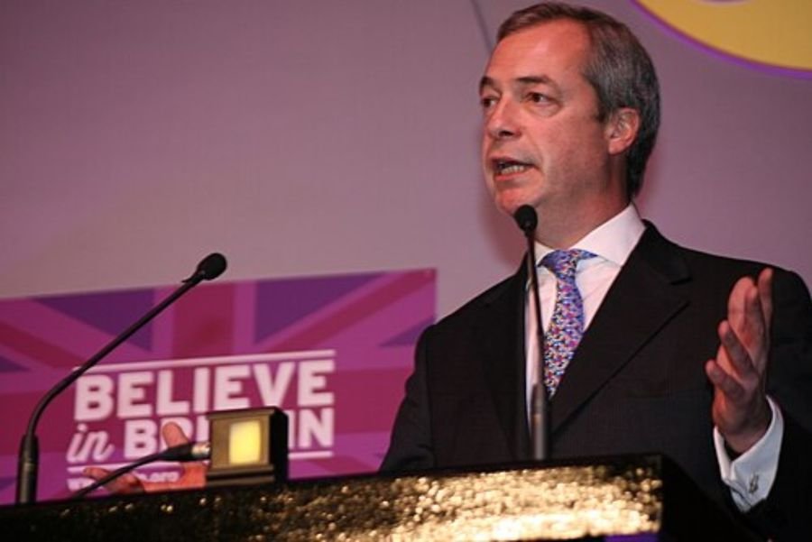 Man speaking at a lectern in front of a purple banner, used in the Brexit Party and Reform UK section