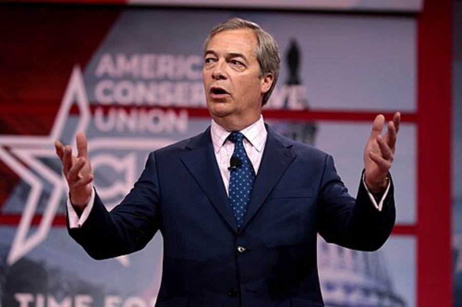 Man in a navy suit speaking on a conference stage, used in the personal life and public scrutiny section