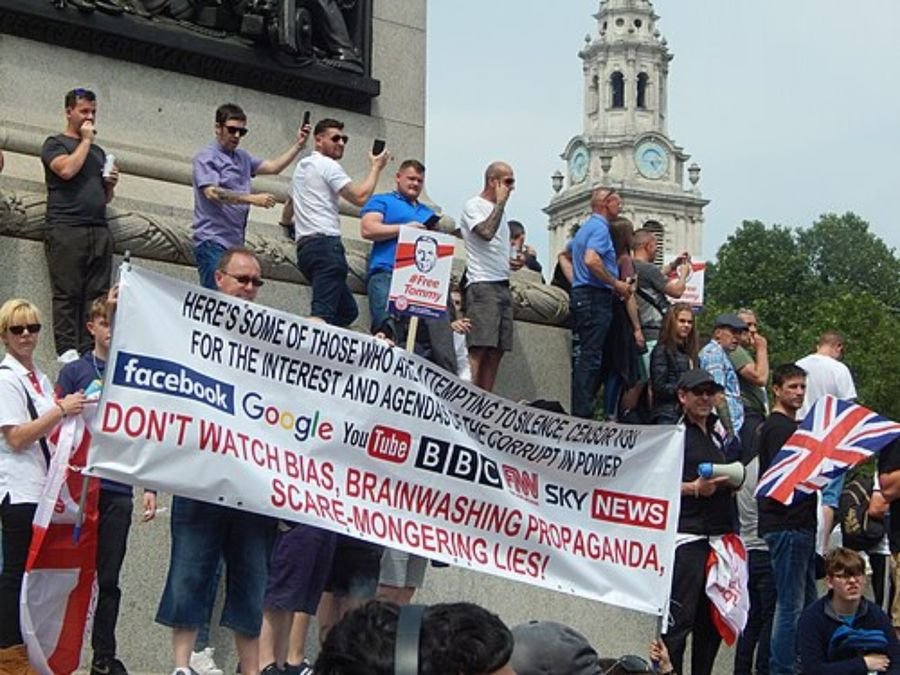 Photo of a rally with a banner criticising media organisations, used in the timeline section