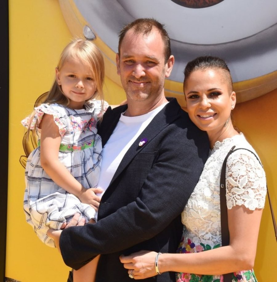 Man, woman and young girl posing together outdoors, shown in the family and legacy section